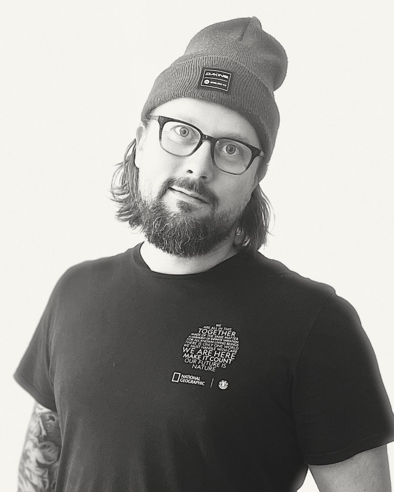 Portrait of Tyler Erdelac in a beanie and glasses